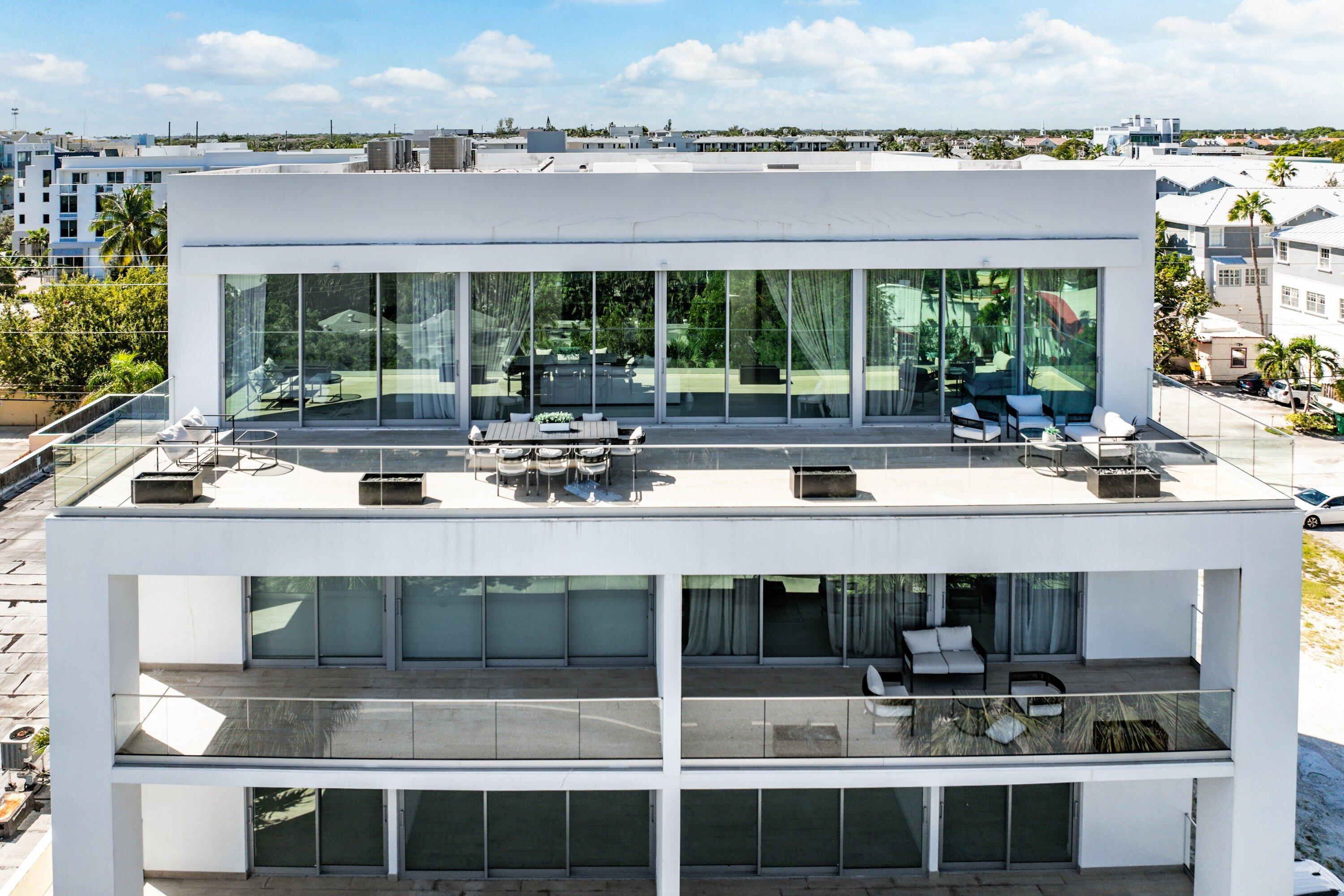 246 Northeast 6th Avenue, Unit PH Delray Beach, FL 33483 - Photo 32 of 36 a view of a swimming pool with outdoor seating and yard in the back