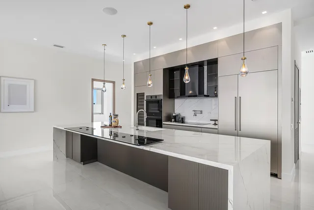 a large kitchen with kitchen island a sink stainless steel appliances and cabinets