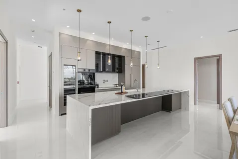 a large kitchen with stainless steel appliances lots of counter top space