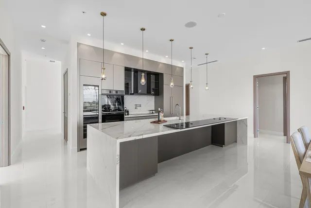 a large kitchen with stainless steel appliances lots of counter top space