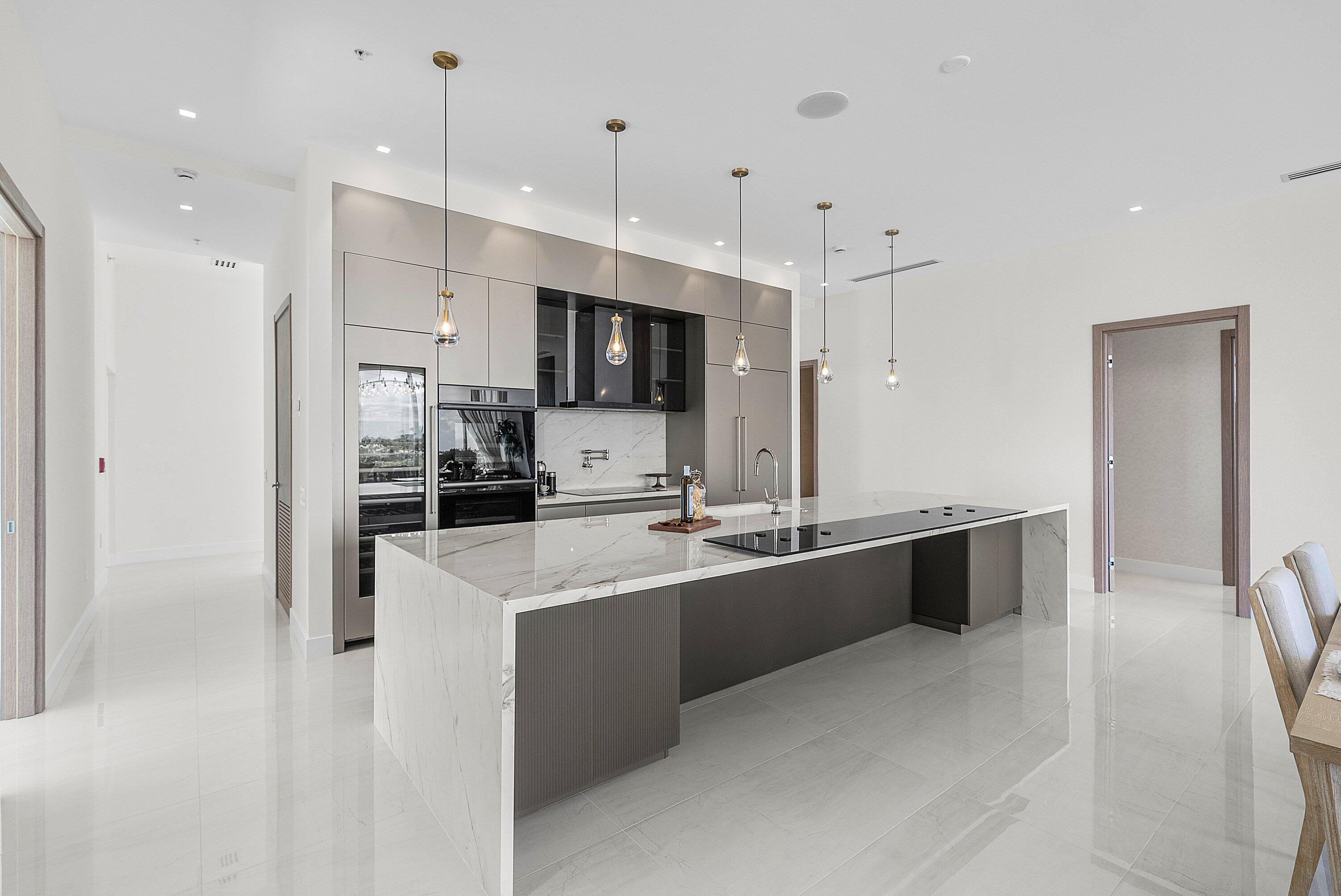 246 Northeast 6th Avenue, Unit PH Delray Beach, FL 33483 - Photo 5 of 36 a large kitchen with stainless steel appliances lots of counter top space