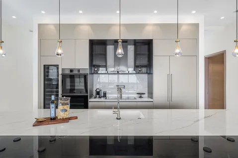 a kitchen with kitchen island stainless steel appliances a sink and cabinets