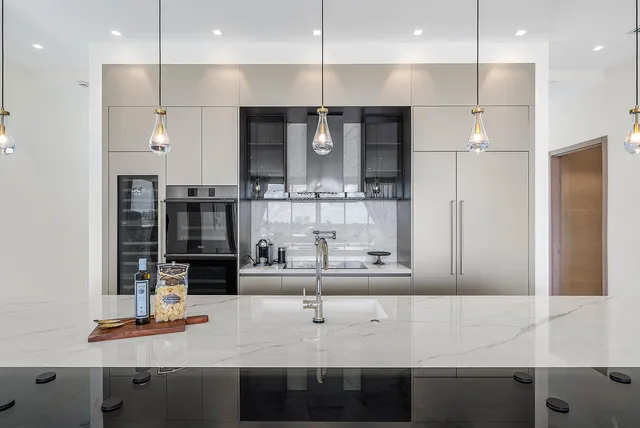 a kitchen with kitchen island stainless steel appliances a sink and cabinets