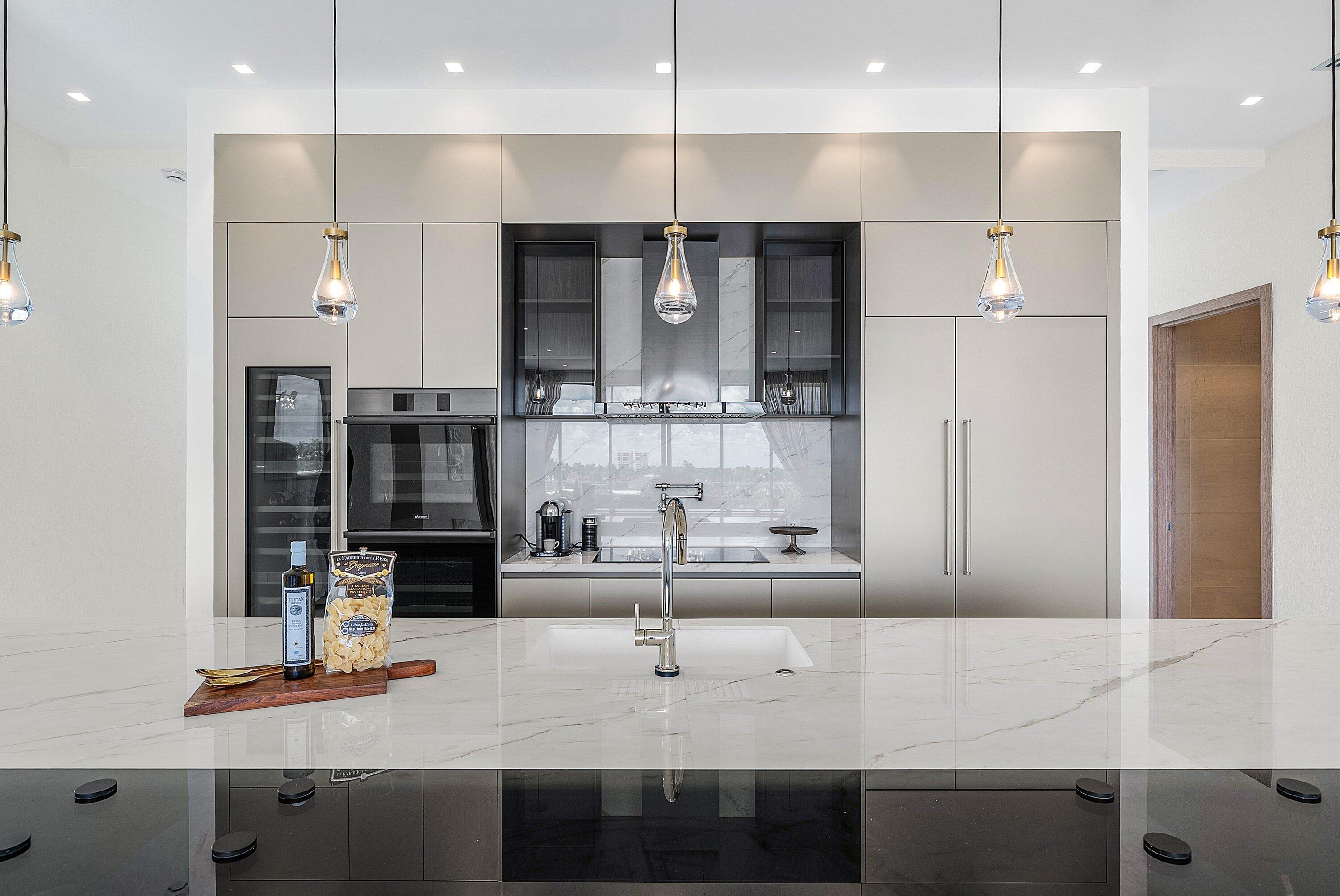 246 Northeast 6th Avenue, Unit PH Delray Beach, FL 33483 - Photo 6 of 36 a kitchen with kitchen island stainless steel appliances a sink and cabinets