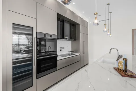 a kitchen with stainless steel appliances kitchen island granite countertop a stove and a refrigerator