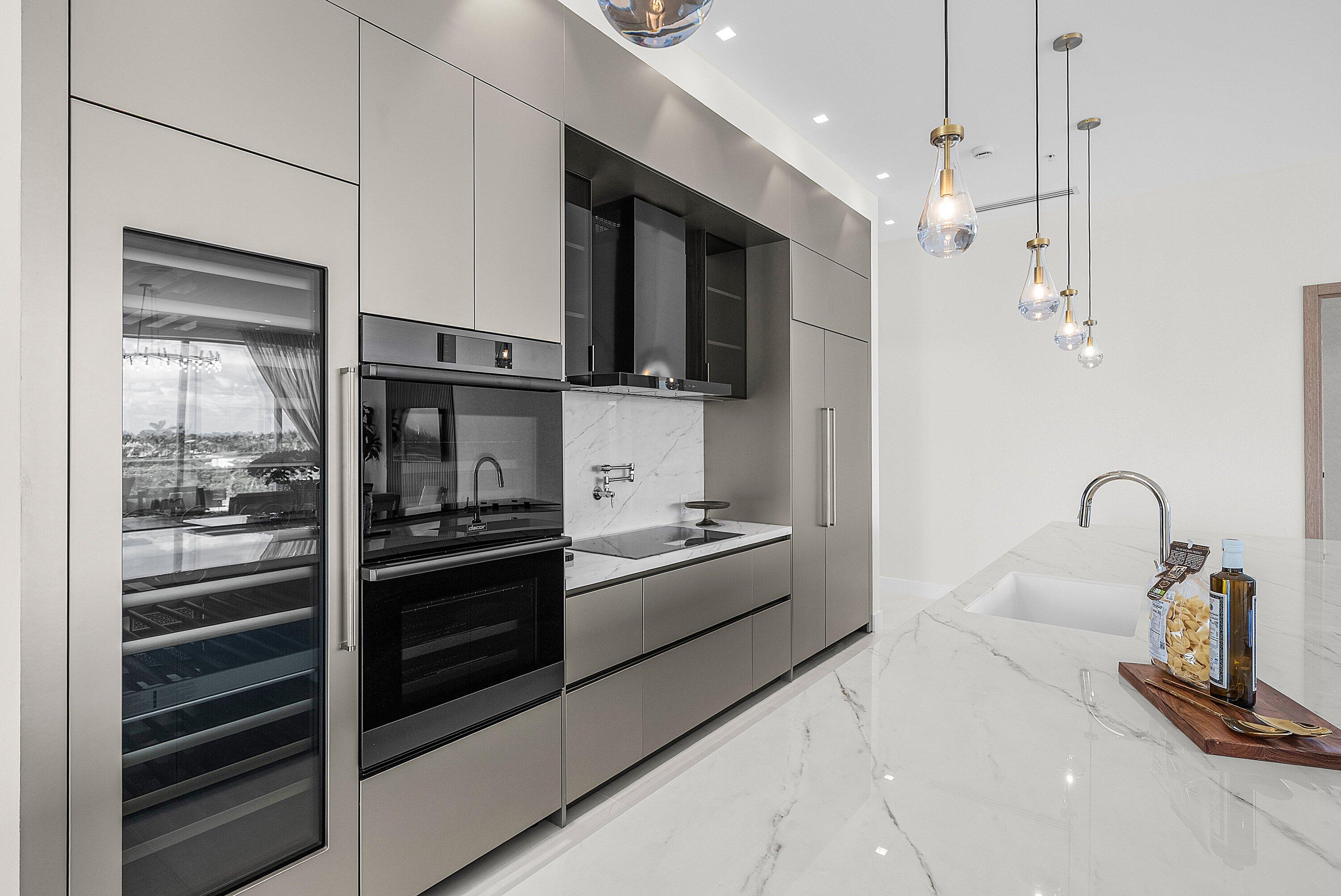246 Northeast 6th Avenue, Unit PH Delray Beach, FL 33483 - Photo 7 of 36 a kitchen with stainless steel appliances kitchen island granite countertop a stove and a refrigerator