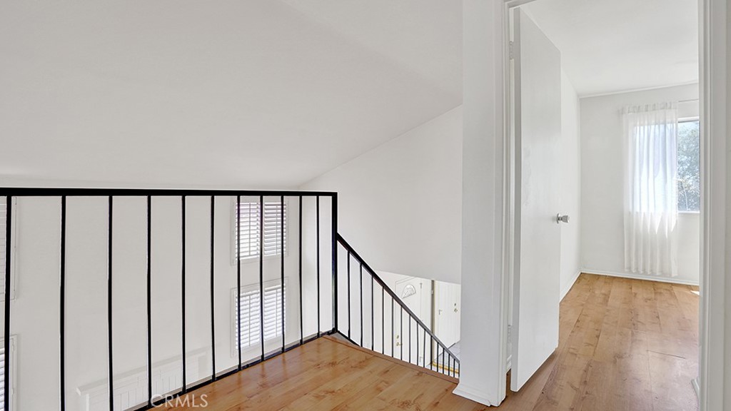2909 Pinewood Court Fullerton, CA 92835 - Photo 21 of 33 a view of a hallway with wooden floor and stairs