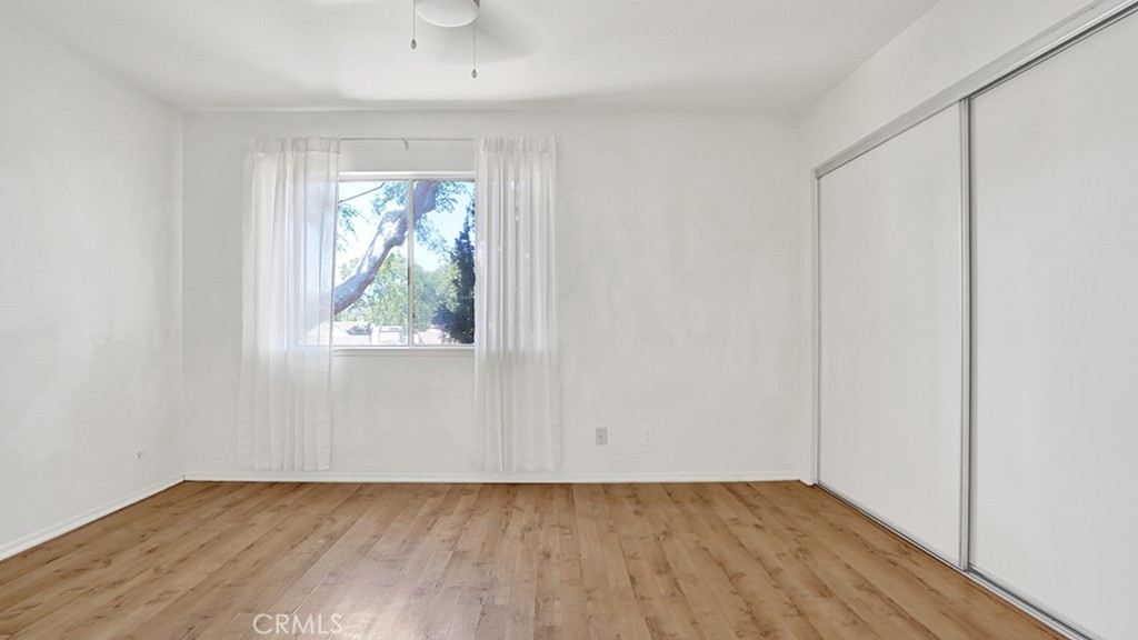 2909 Pinewood Court Fullerton, CA 92835 - Photo 23 of 33 an empty room with wooden floor and windows