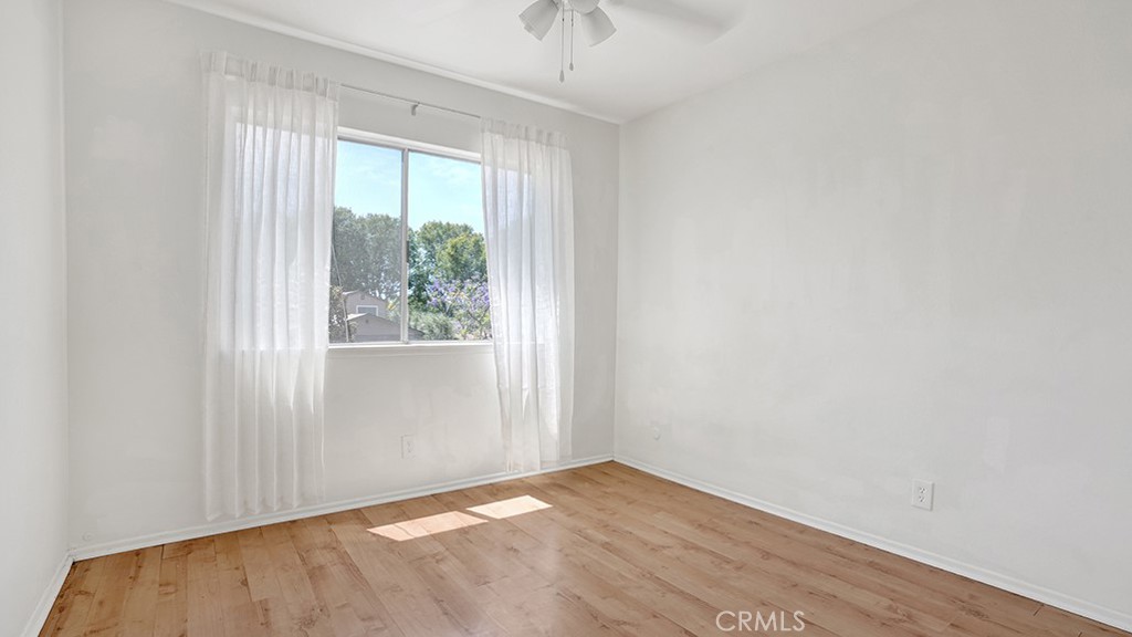 2909 Pinewood Court Fullerton, CA 92835 - Photo 27 of 33 an empty room with wooden floor and windows