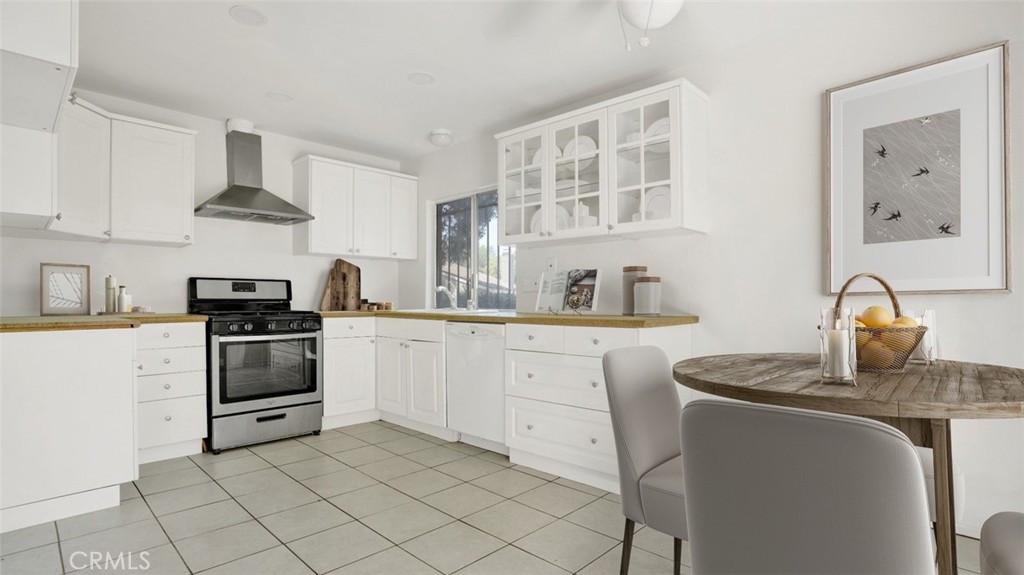 2909 Pinewood Court Fullerton, CA 92835 - Photo 6 of 33 a kitchen with stainless steel appliances granite countertop white cabinets a stove top oven a sink and dishwasher