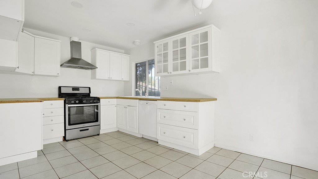 2909 Pinewood Court Fullerton, CA 92835 - Photo 7 of 33 a kitchen with white cabinets and appliances