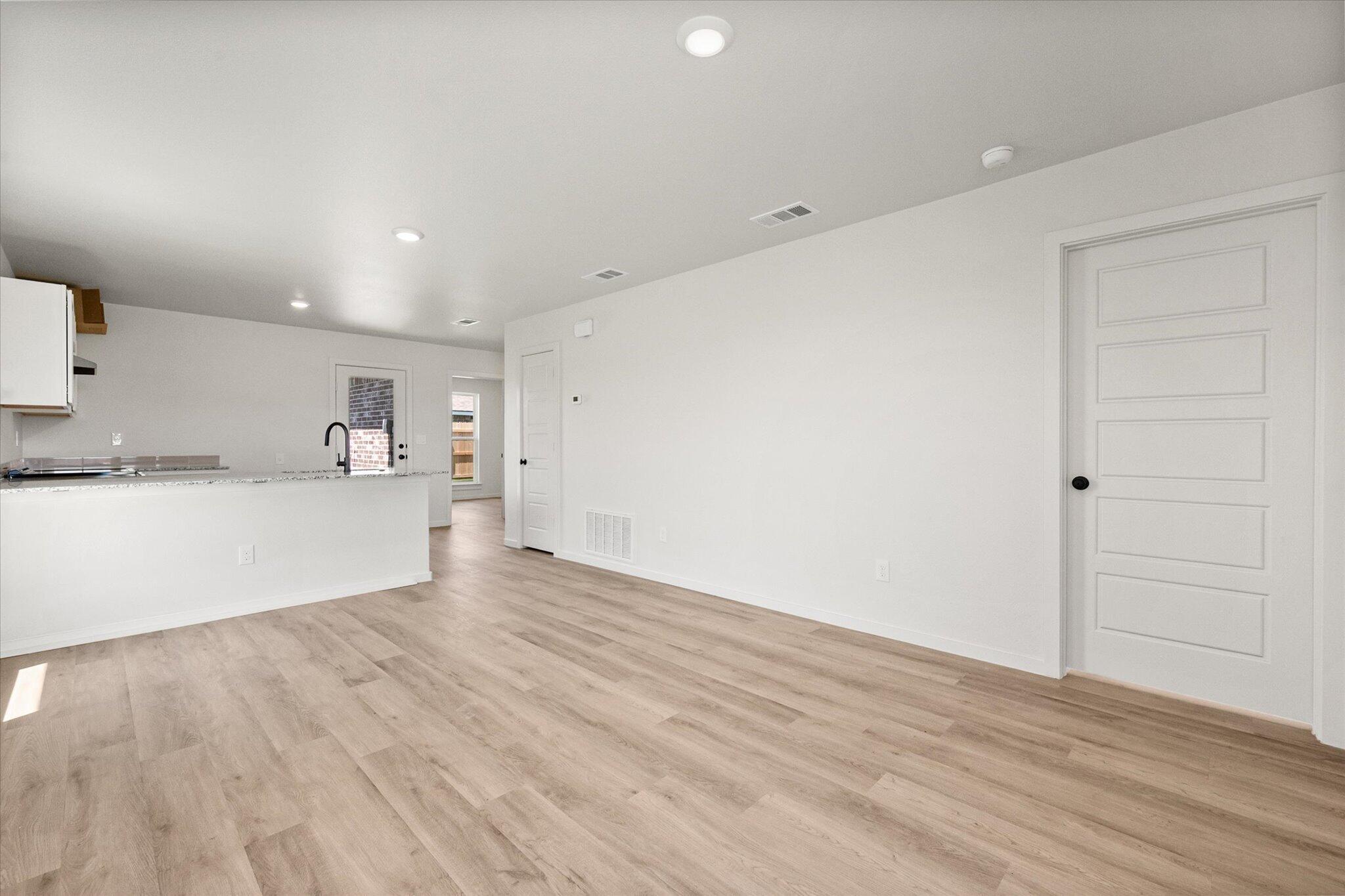 8312 25th Street Lubbock, TX 79407 - Photo 5 of 17 a view of a kitchen with wooden floor