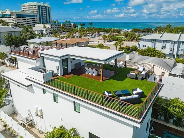 an aerial view of a house with a yard and lake view