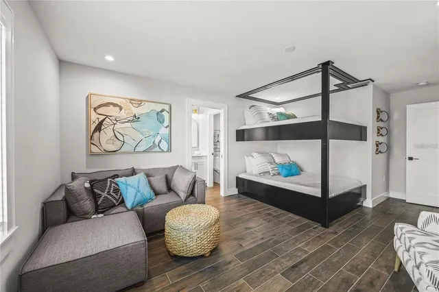 a bedroom with a bed painting and window