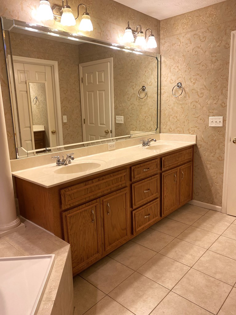 6008 Walters Loop Columbus, GA 31907 - Photo 19 of 33 a bathroom with a sink vanity and mirror