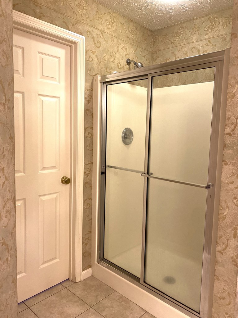 6008 Walters Loop Columbus, GA 31907 - Photo 22 of 33 a bathroom with a glass shower door
