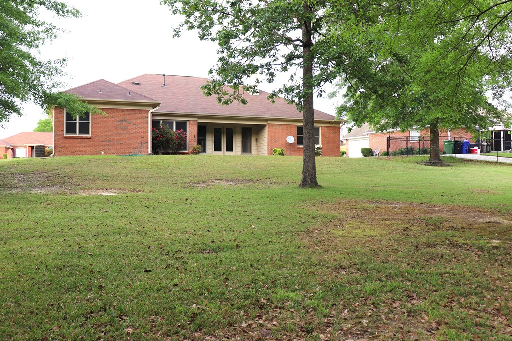6008 Walters Loop Columbus, GA 31907 - Photo 28 of 33 a view of a yard in front of a house with plants and large tree