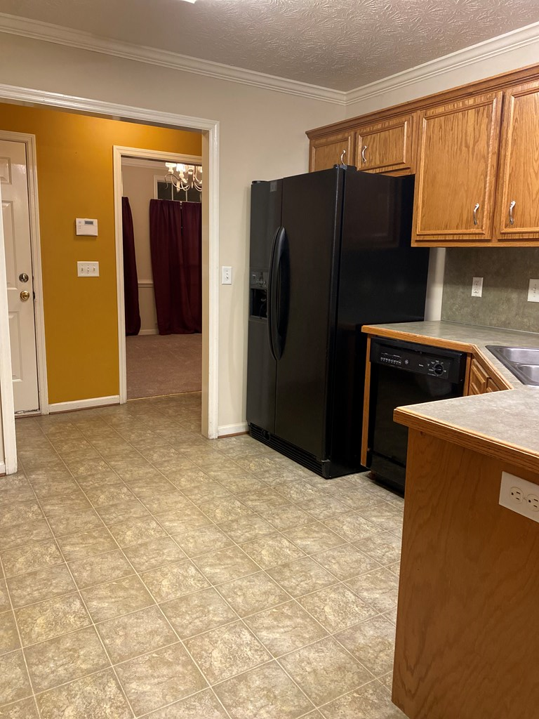 6008 Walters Loop Columbus, GA 31907 - Photo 9 of 33 a kitchen with a refrigerator and cabinets
