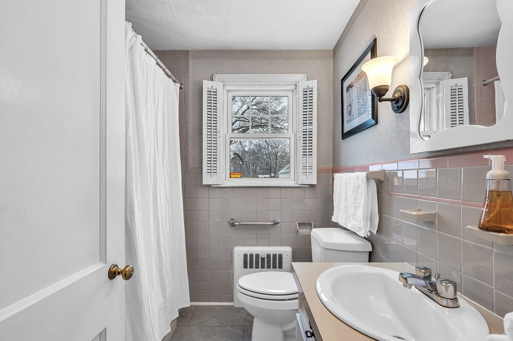 20 Lenox Road Holyoke, MA 01040 - Photo 17 of 36 a bathroom with a toilet sink and mirror