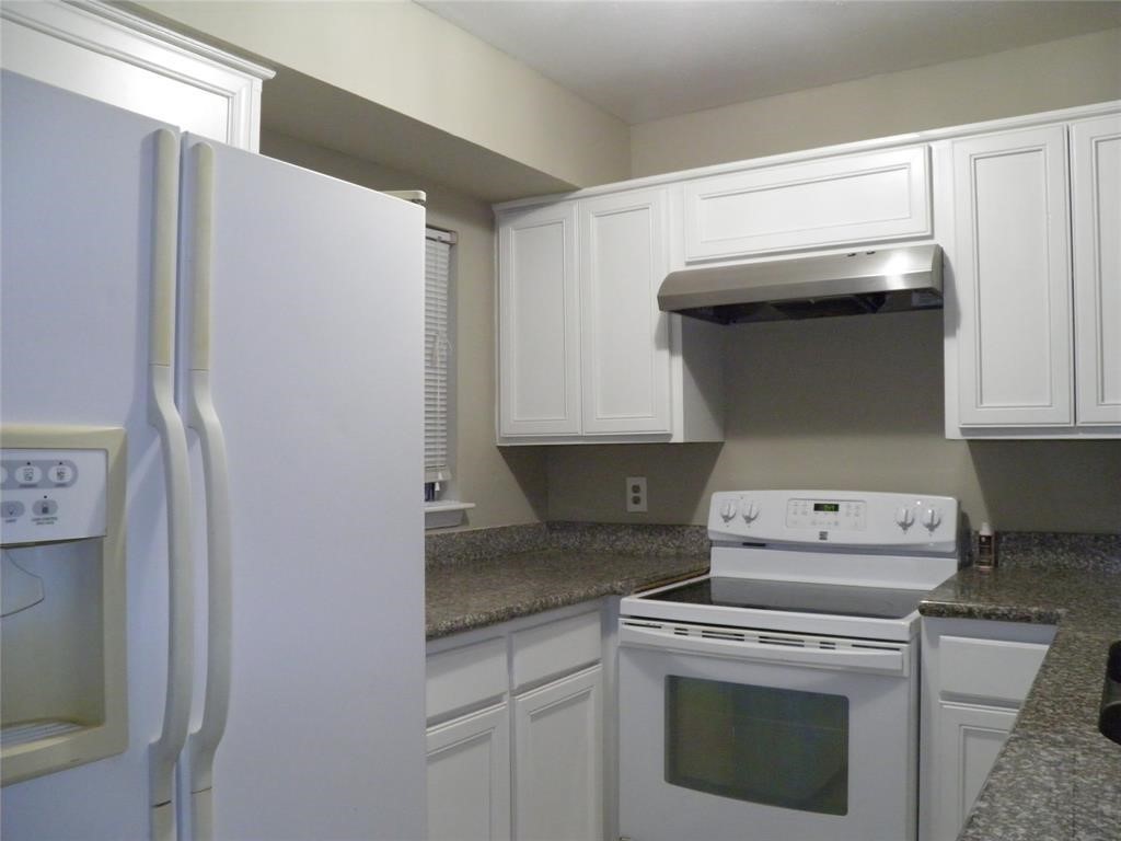 9901 Sharpcrest Street, Unit D1 Houston, TX 77036 - Photo 5 of 8 a kitchen with a stove and a refrigerator