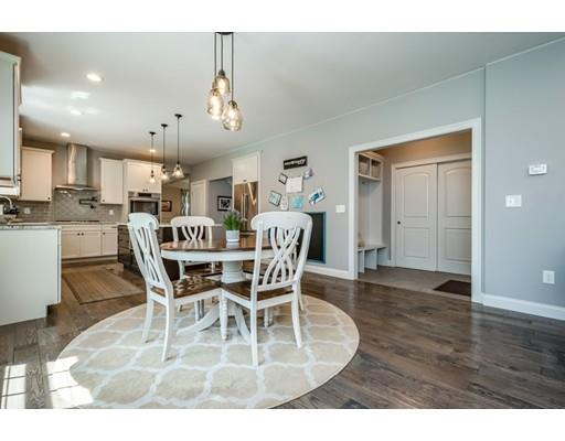 320 West Acton Road Stow, MA 01775 - Photo 13 of 39 a view of a dining room and livingroom with furniture wooden floor a chandelier