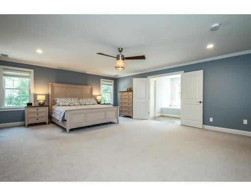 320 West Acton Road Stow, MA 01775 - Photo 18 of 39 a spacious bedroom with a bed and a ceiling fan