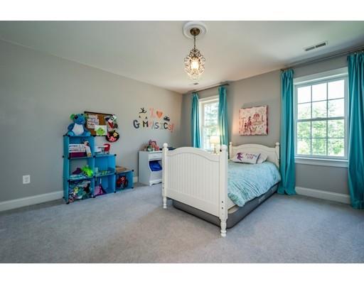 320 West Acton Road Stow, MA 01775 - Photo 27 of 39 a bedroom with a bed and a chandelier