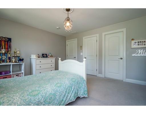 320 West Acton Road Stow, MA 01775 - Photo 28 of 39 a spacious bedroom with a bed and a chandelier