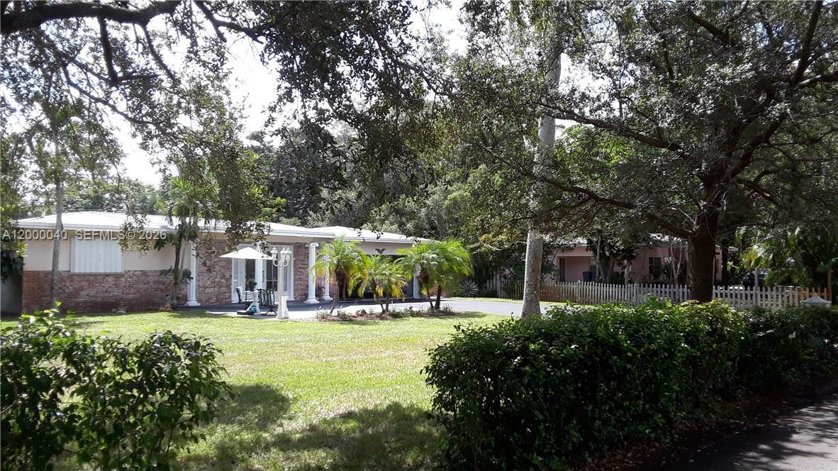 a view of outdoor space with garden and trees