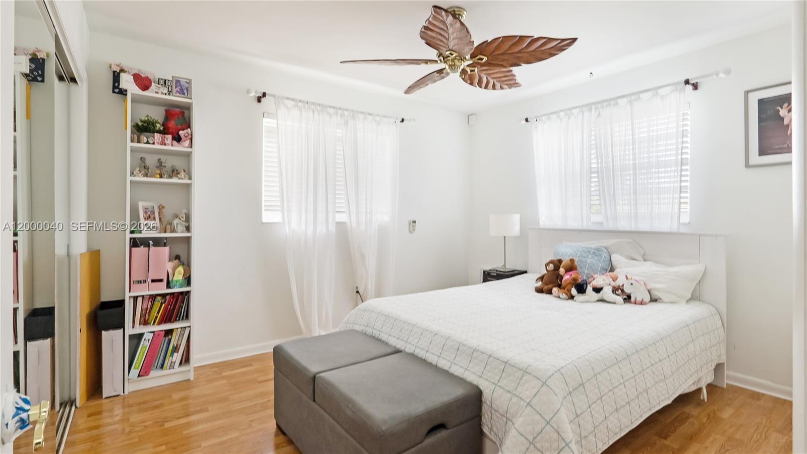 4020 Southwest 2nd Street Plantation, FL 33317 - Photo 13 of 43 a bedroom with a bed and a book shelf