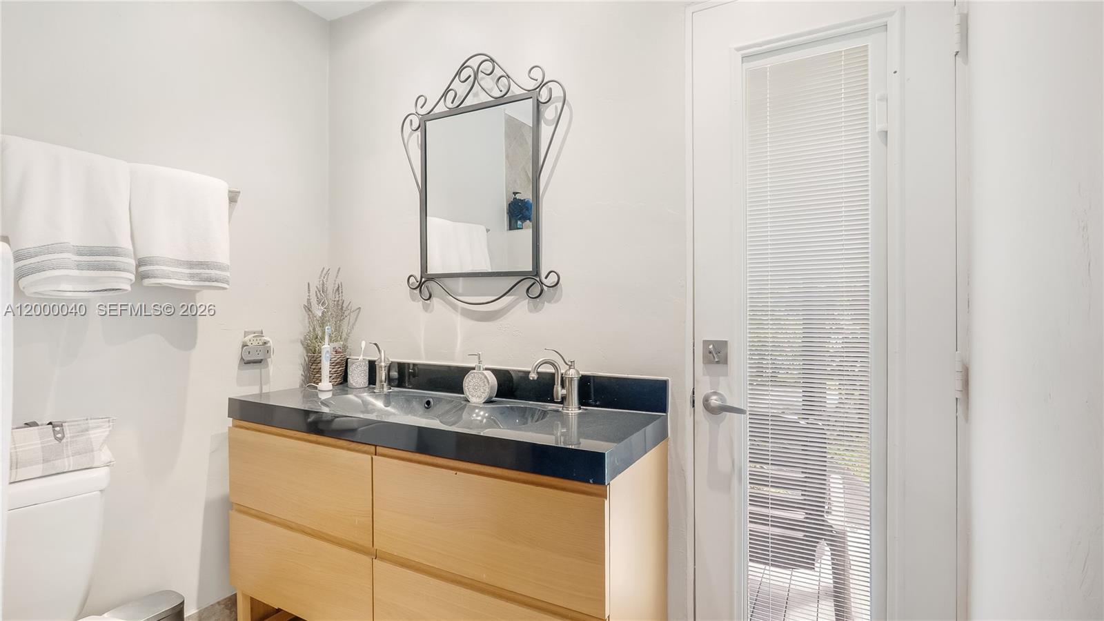 4020 Southwest 2nd Street Plantation, FL 33317 - Photo 23 of 43 a bathroom with a granite countertop sink and a mirror