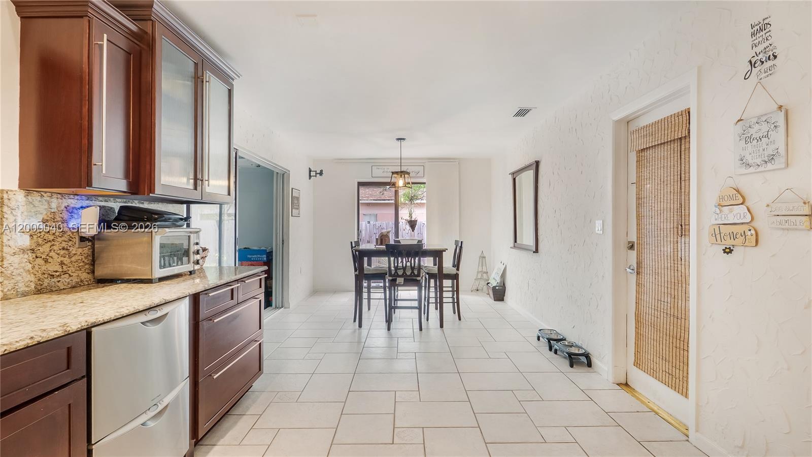 4020 Southwest 2nd Street Plantation, FL 33317 - Photo 26 of 43 a kitchen with stainless steel appliances a sink and cabinets