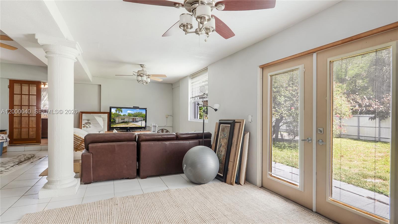 4020 Southwest 2nd Street Plantation, FL 33317 - Photo 40 of 43 a living room with furniture a flat screen tv and a large window