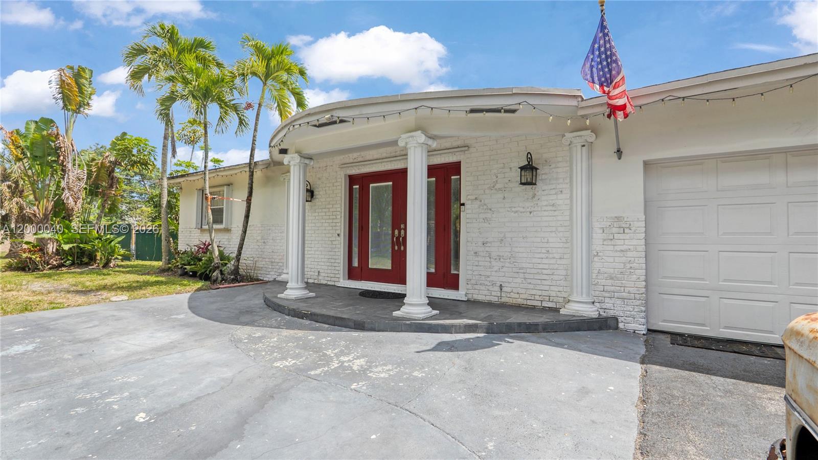 4020 Southwest 2nd Street Plantation, FL 33317 - Photo 8 of 43 a front view of a house with a yard and garage