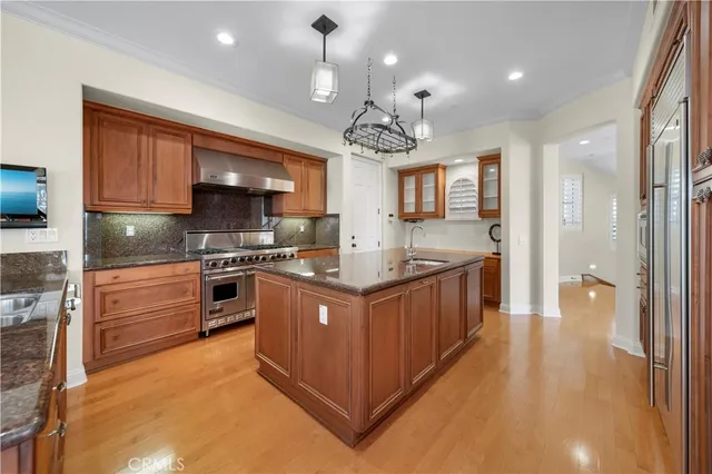 a kitchen with stainless steel appliances granite countertop a stove and a refrigerator