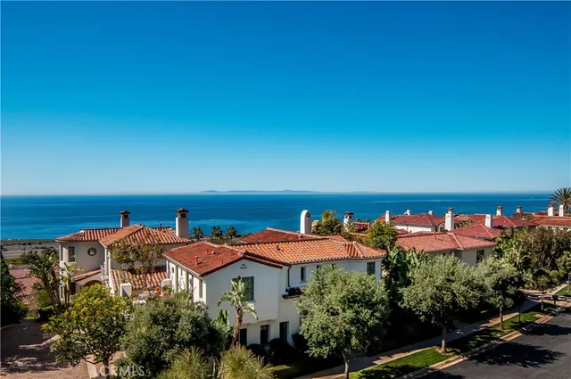 an aerial view of a houses with an outdoor space and seating