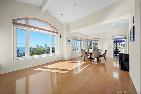 a dining room with furniture a rug and wooden floor
