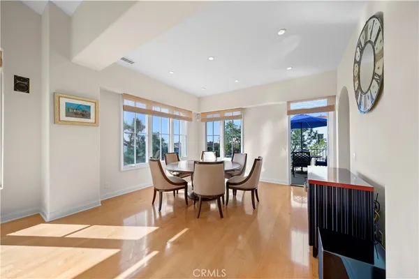 a dining room with furniture and wooden floor