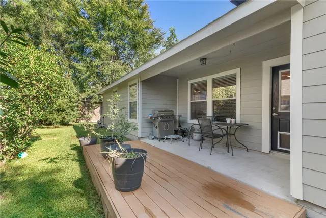 a living room with patio furniture and a potted plant