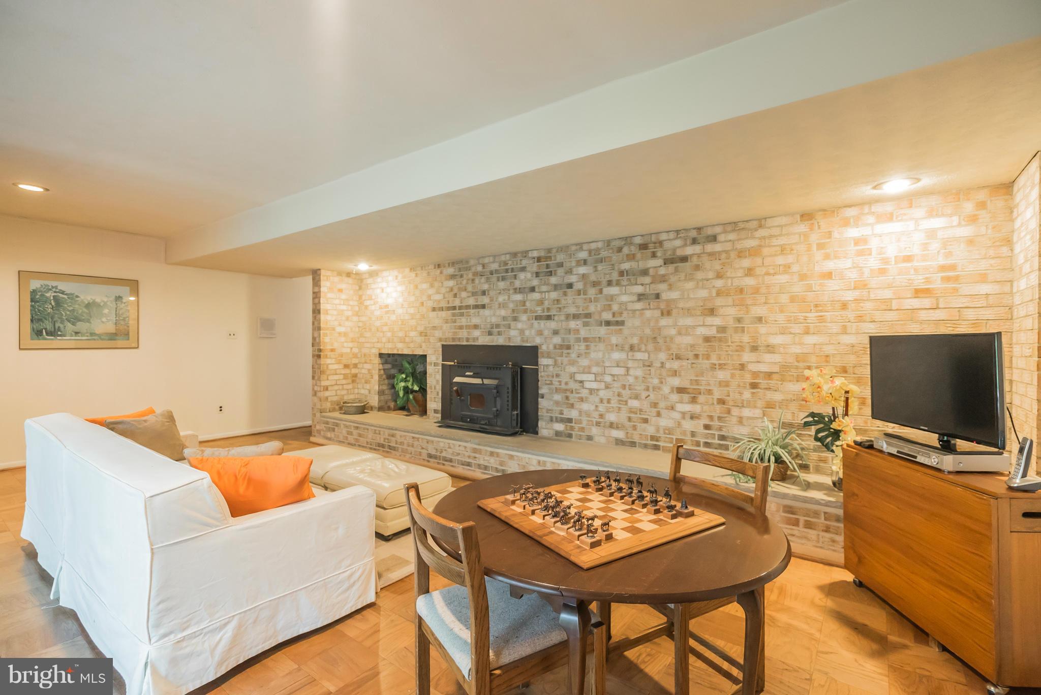 10217 Lloyd Road Potomac, MD 20854 - Photo 20 of 28 Family Room with Wood Stove and Brick Wood Box