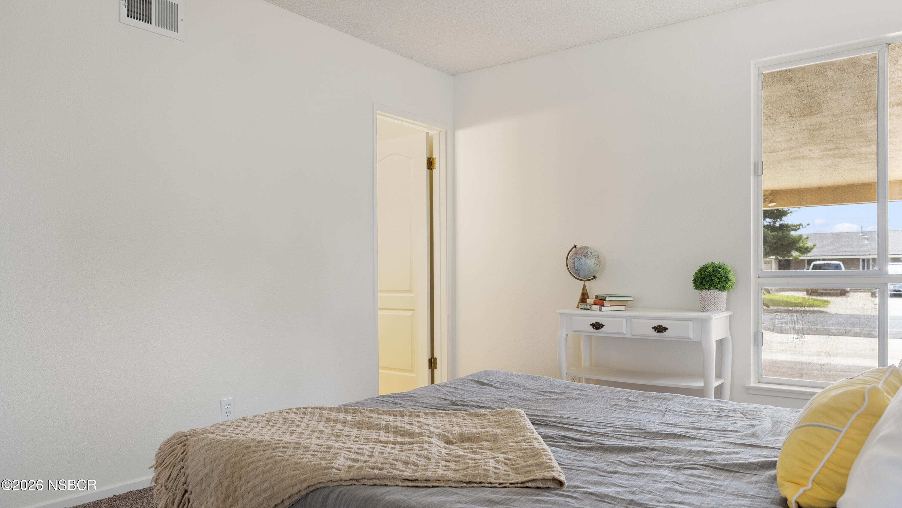 1312 North First Place Lompoc, CA 93436 - Photo 27 of 38 a bedroom with a bed and wooden floor