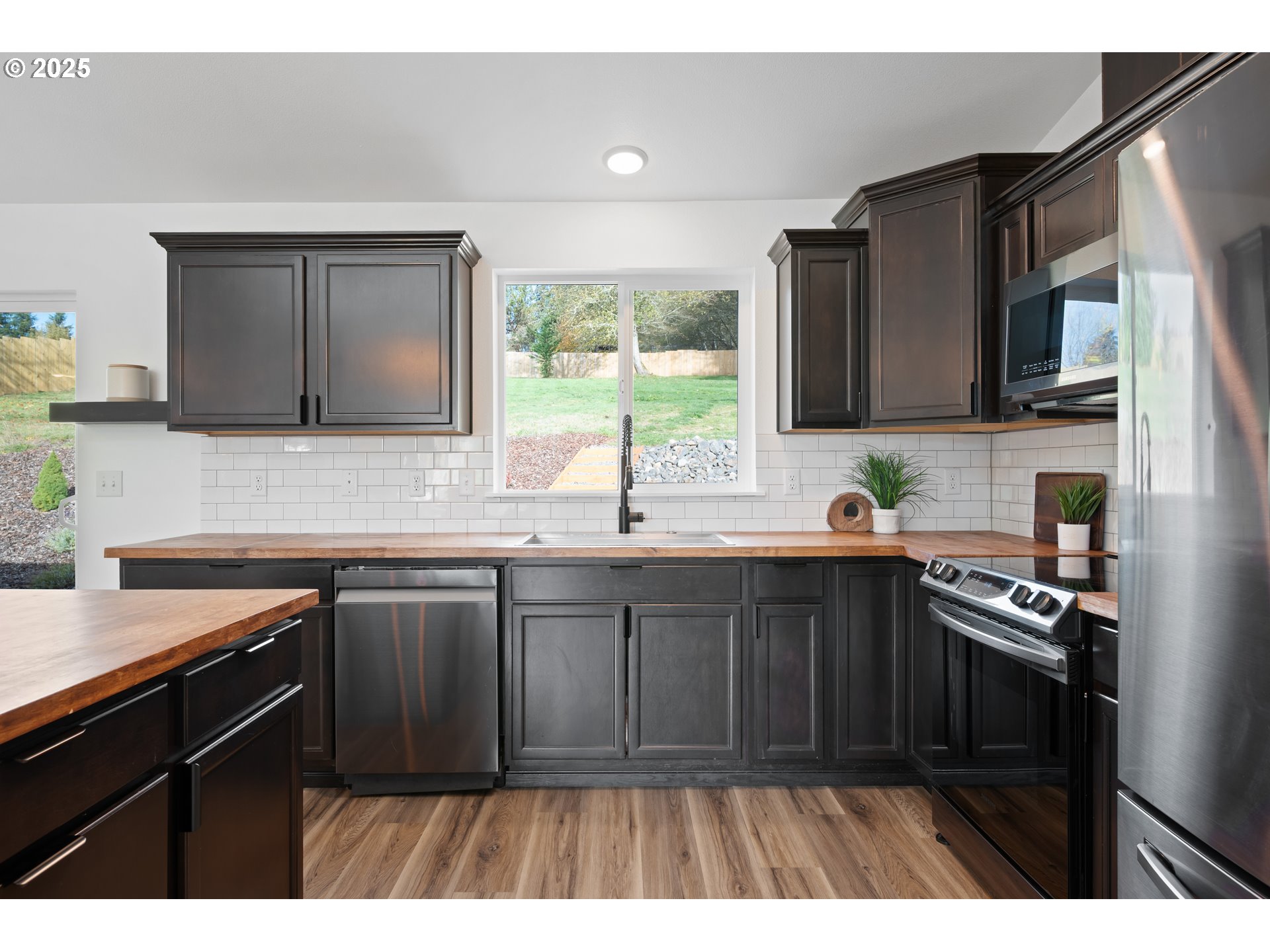 940 Stella Road Longview, WA 98632 - Photo 8 of 39 a kitchen with a sink stove top oven and cabinets