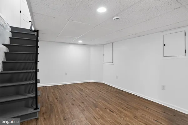 a view of room with stairs and wooden floor