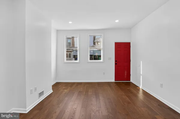 a view of wooden floor and windows in a room