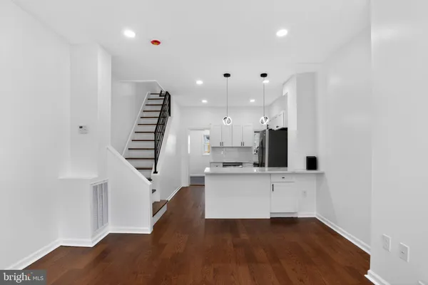 a view of kitchen with wooden floor and electronic appliances