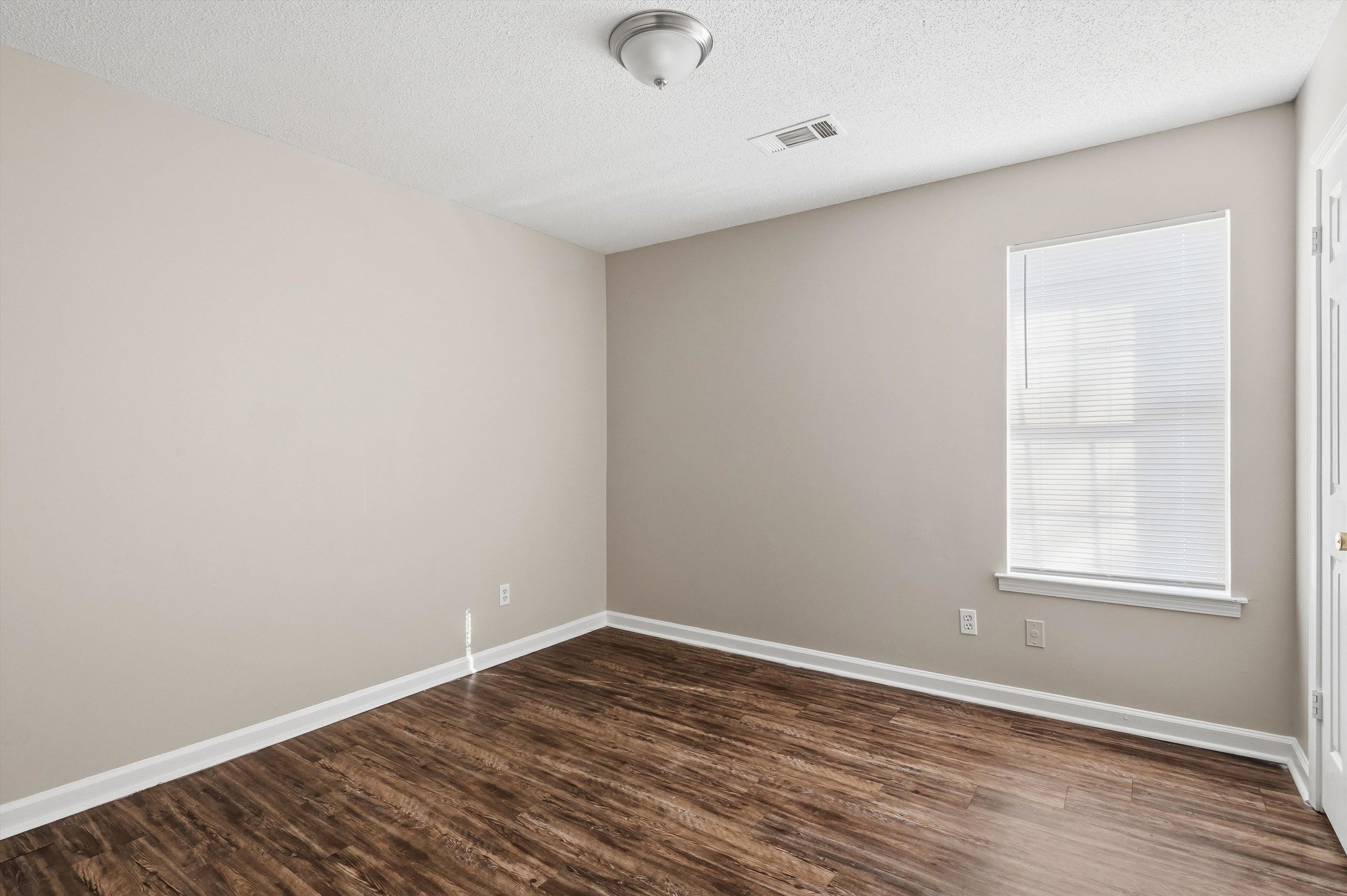 6030 Chadwell Road Millington, TN 38053 - Photo 17 of 28 an empty room with wooden floor and windows
