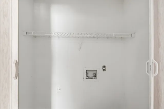 a view of a closet with racks on the wall