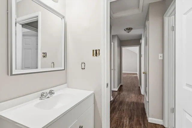 a bathroom with a sink a mirror and a shower