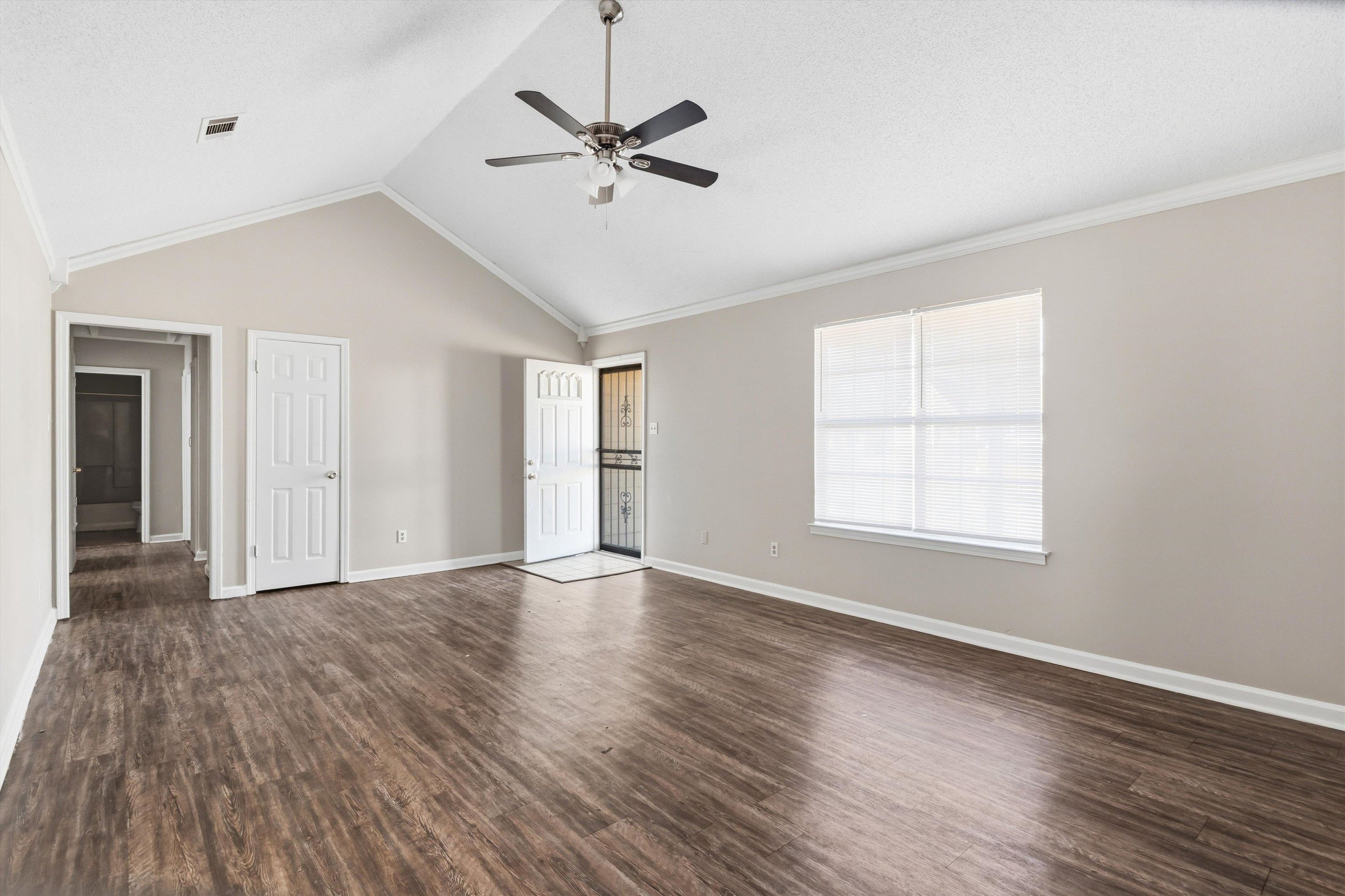 6030 Chadwell Road Millington, TN 38053 - Photo 5 of 28 an empty room with wooden floor fan and windows