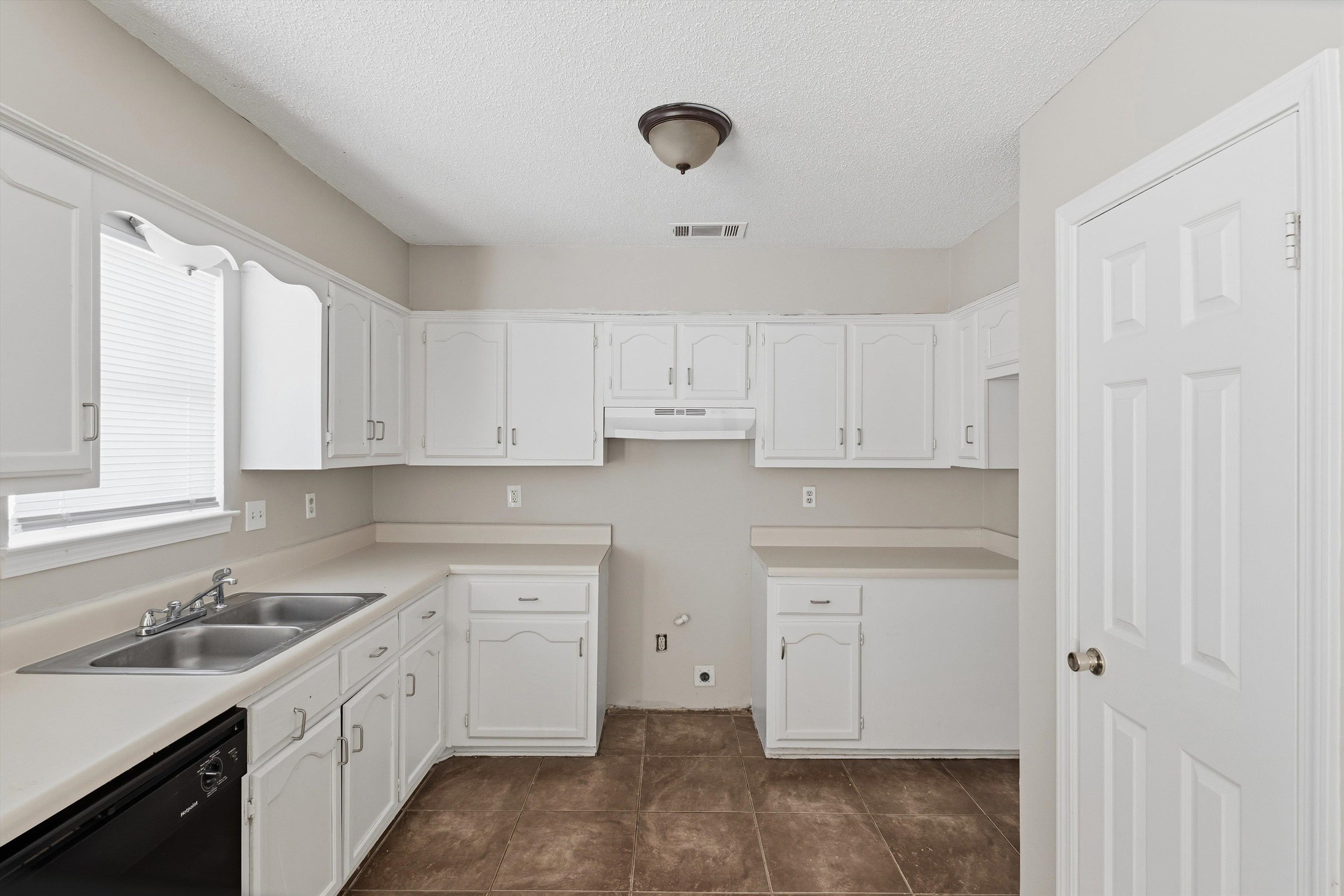 6030 Chadwell Road Millington, TN 38053 - Photo 8 of 28 a kitchen with cabinets appliances a sink and a window